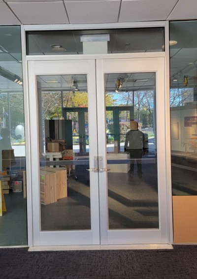 Pair of Medium style aluminum doors with concealed vertical panic exit devices.